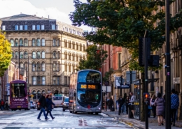 Bus at a busy intersection in Manchester.