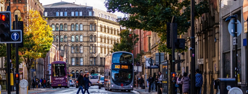 Bus at a busy intersection in Manchester.