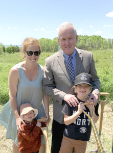Mayor standing in a field with his family.