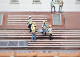 Workers in hard hats installing solar panels